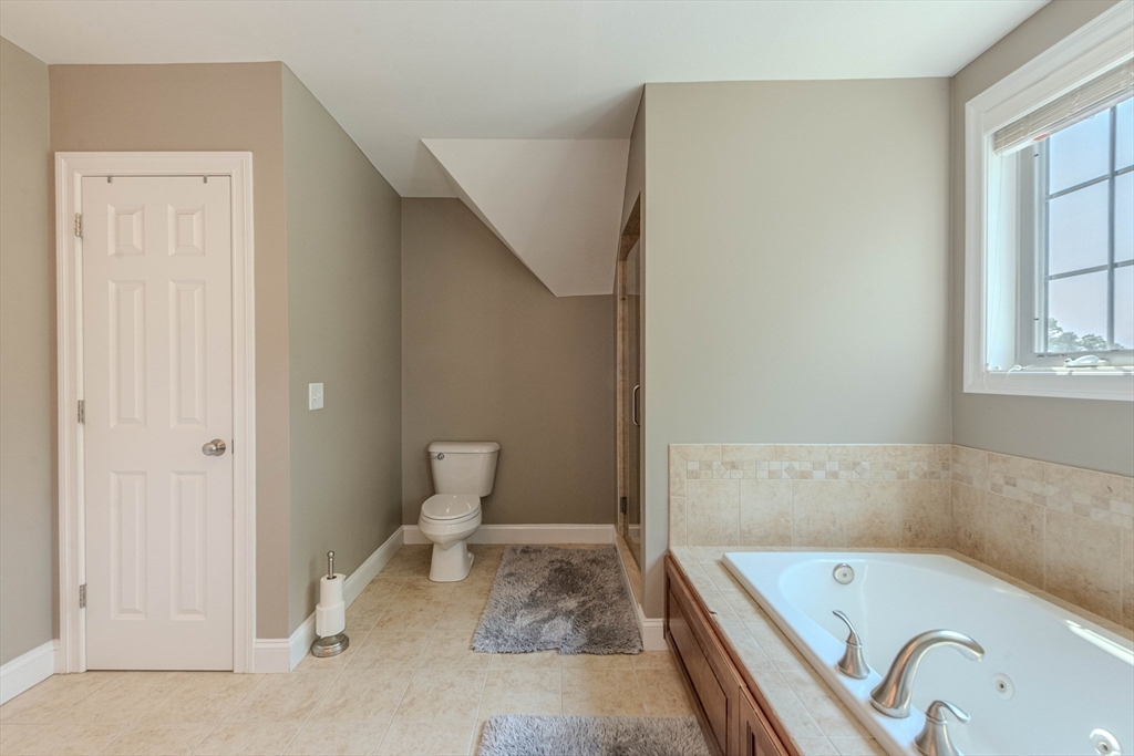22 Jacob Road Windham, NH 03087 - Photo 22 of 42 a bathroom with a tub sink and toilet