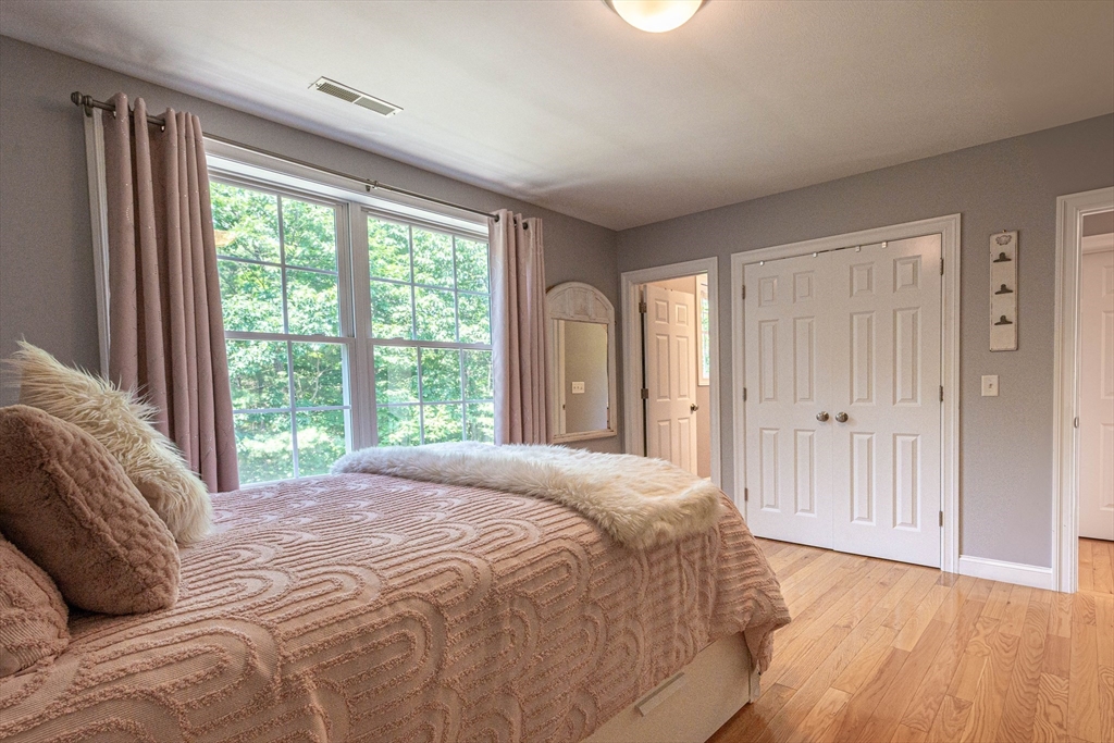 22 Jacob Road Windham, NH 03087 - Photo 25 of 42 a bedroom with a bed and a large window