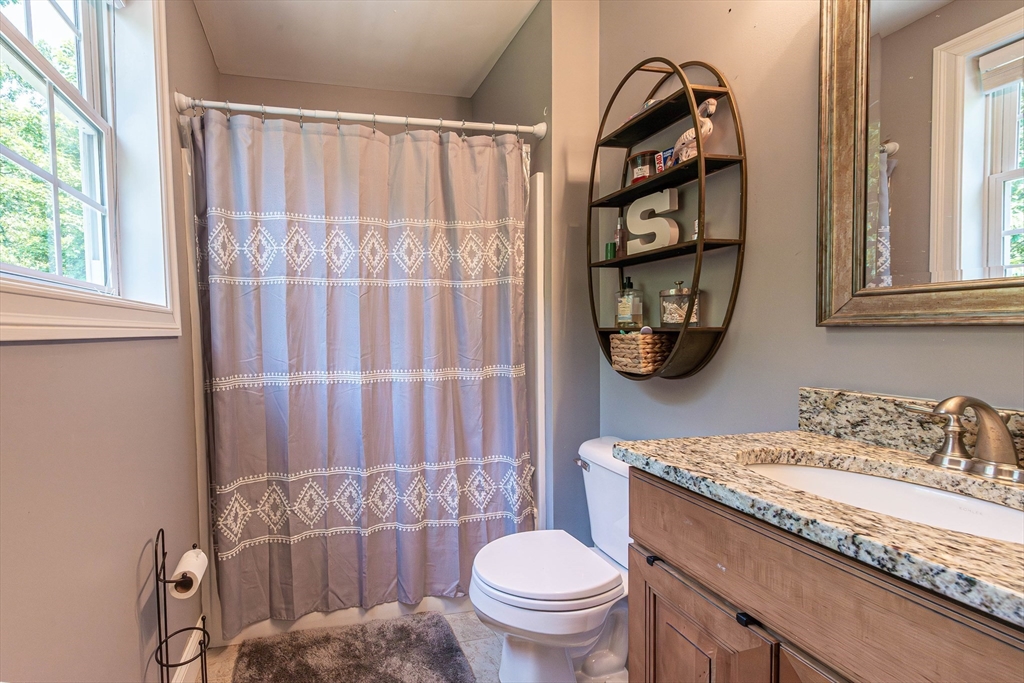22 Jacob Road Windham, NH 03087 - Photo 26 of 42 a bathroom with a granite countertop sink mirror vanity and toilet