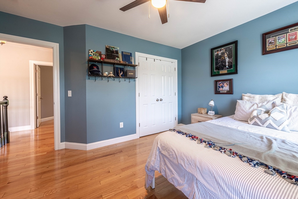 22 Jacob Road Windham, NH 03087 - Photo 30 of 42 a bedroom with a bed and a chandelier