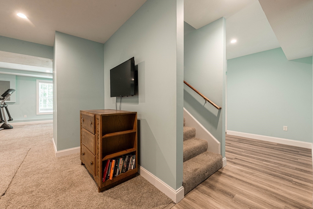 22 Jacob Road Windham, NH 03087 - Photo 32 of 42 a living room with furniture and a flat screen tv