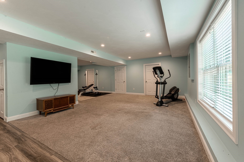 22 Jacob Road Windham, NH 03087 - Photo 34 of 42 a living room with furniture and a flat screen tv