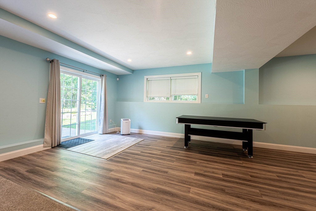 22 Jacob Road Windham, NH 03087 - Photo 35 of 42 a room with wooden floor and furniture