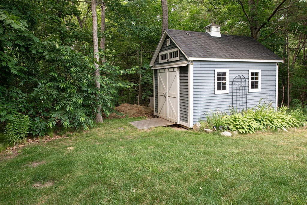 22 Jacob Road Windham, NH 03087 - Photo 40 of 42 a house with a small yard and large trees