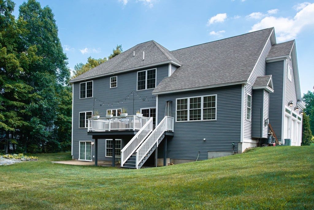 22 Jacob Road Windham, NH 03087 - Photo 41 of 42 a front view of a house with a garden and deck