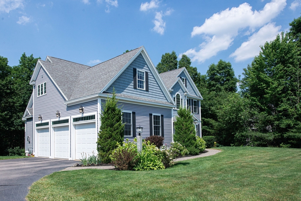 22 Jacob Road Windham, NH 03087 - Photo 42 of 42 a front view of a house with a yard and potted plants