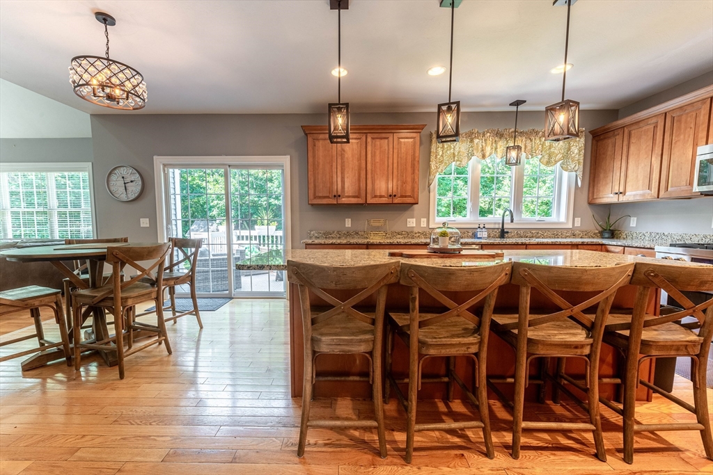 22 Jacob Road Windham, NH 03087 - Photo 5 of 42 a kitchen with a table chairs sink and cabinets