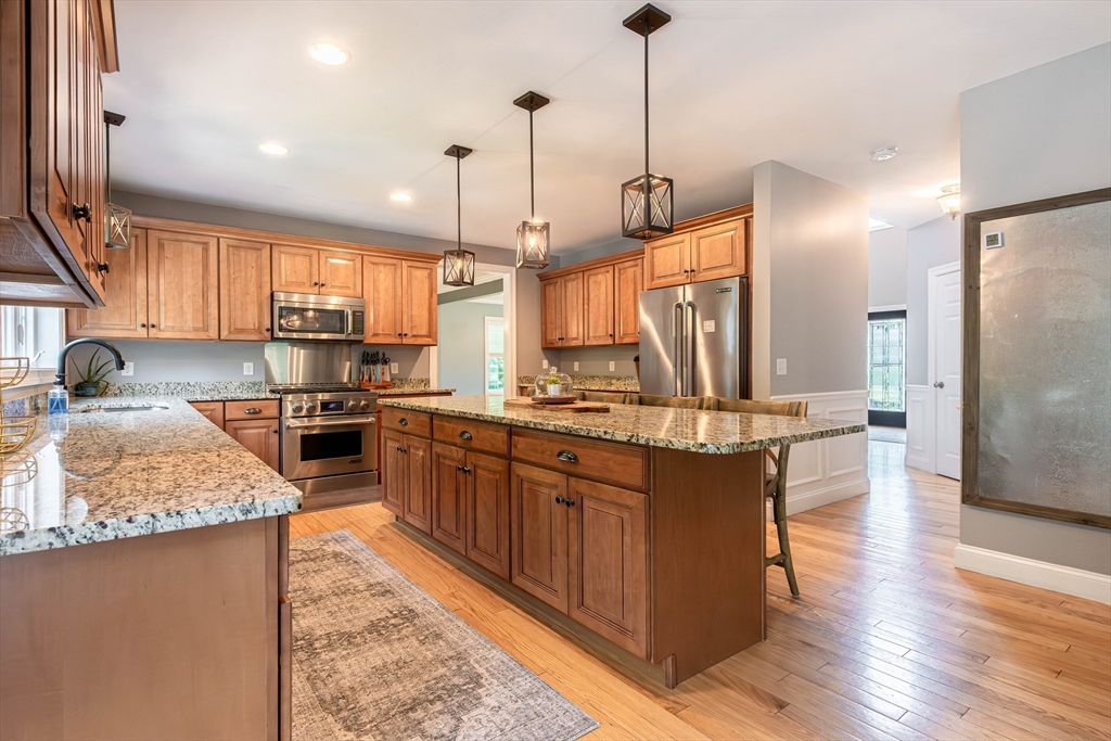 22 Jacob Road Windham, NH 03087 - Photo 6 of 42 a kitchen with stainless steel appliances granite countertop sink stove top oven and refrigerator