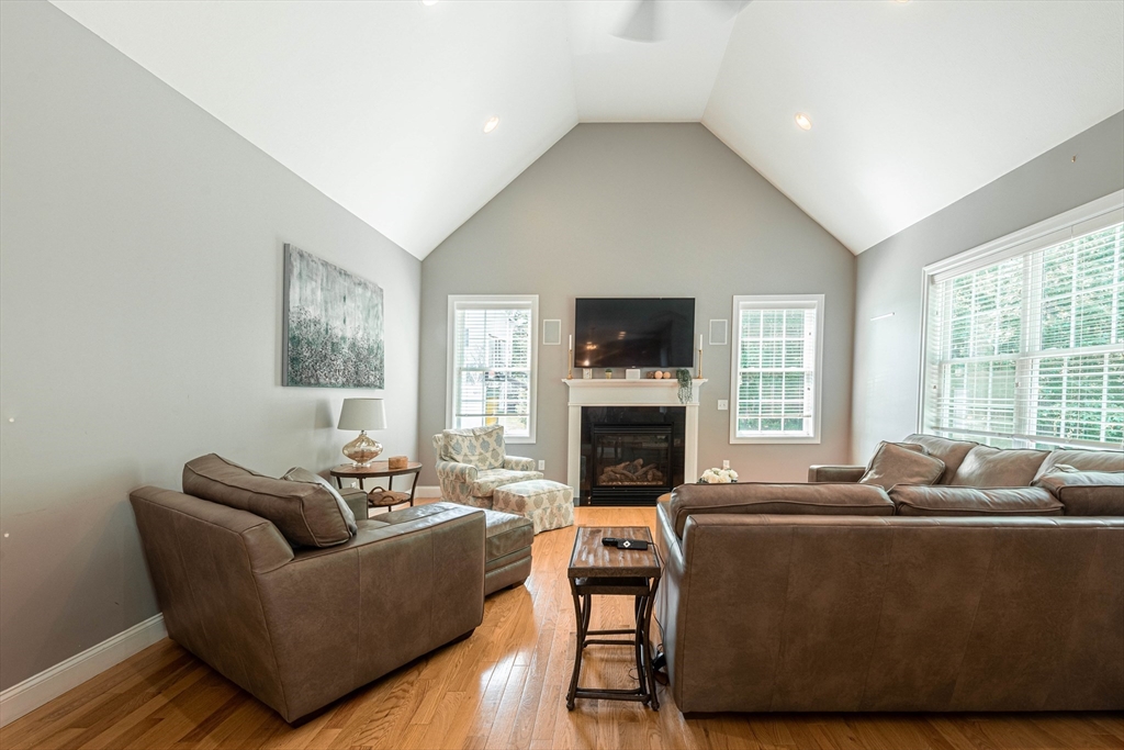 22 Jacob Road Windham, NH 03087 - Photo 10 of 42 a living room with furniture and a fireplace