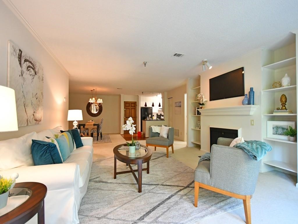 303 Ridley Howard Court Decatur, GA 30030 - Photo 1 of 1 a living room with furniture a fireplace and a flat screen tv