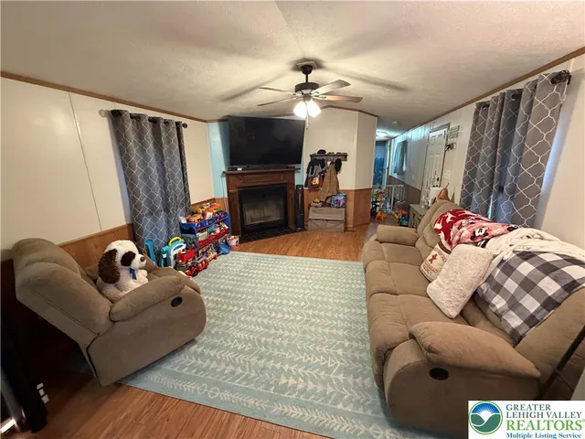 a living room with furniture a flat screen tv and a fireplace