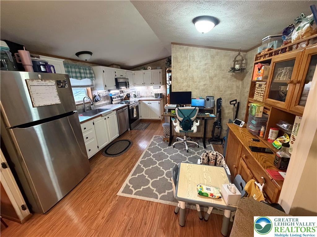 6318 Lamar Court Slatington, PA 18080 - Photo 7 of 18 a kitchen with stainless steel appliances granite countertop a refrigerator and a stove top oven
