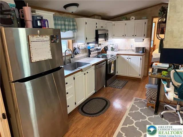 a kitchen with a sink a stove and cabinets