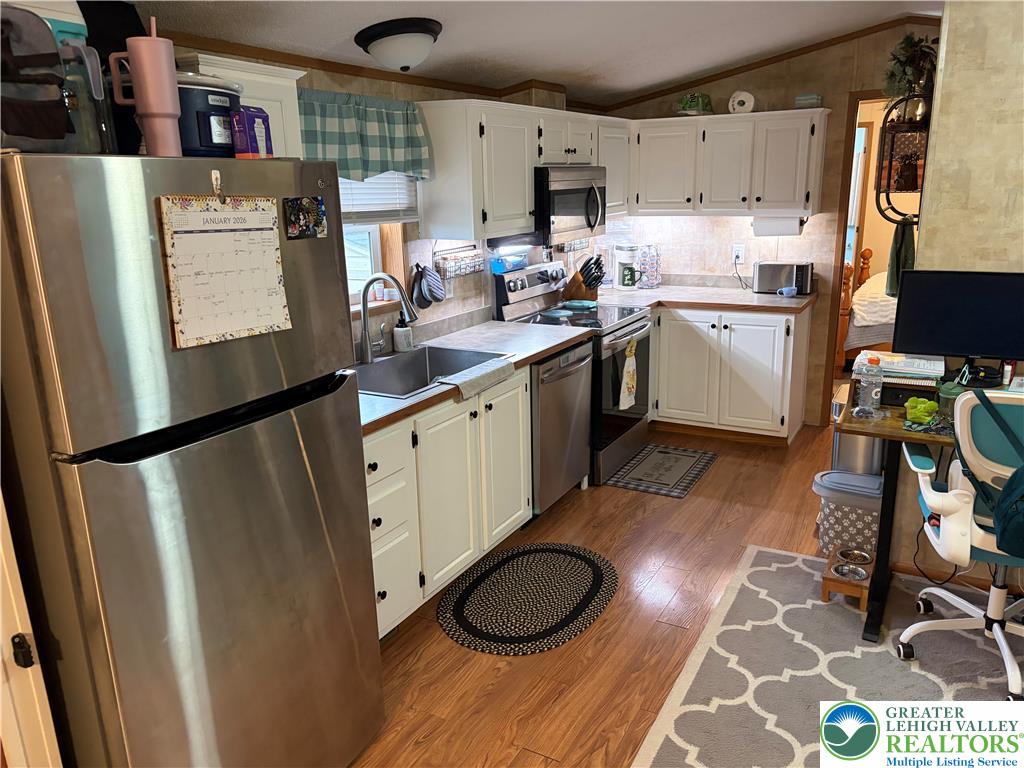 6318 Lamar Court Slatington, PA 18080 - Photo 8 of 18 a kitchen with a sink a refrigerator and wooden floor