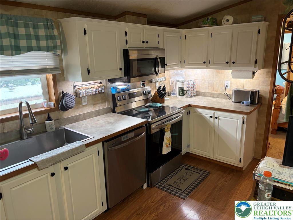 6318 Lamar Court Slatington, PA 18080 - Photo 9 of 18 a kitchen with a sink a stove and cabinets