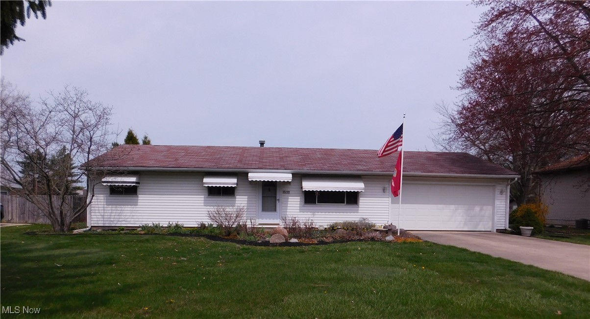 9255 Root Road North Ridgeville, OH 44039 - Photo 1 of 46 Single story home featuring a garage, driveway, a front lawn, and fence