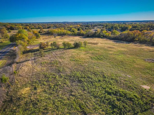 a view of a field with an ocean beach