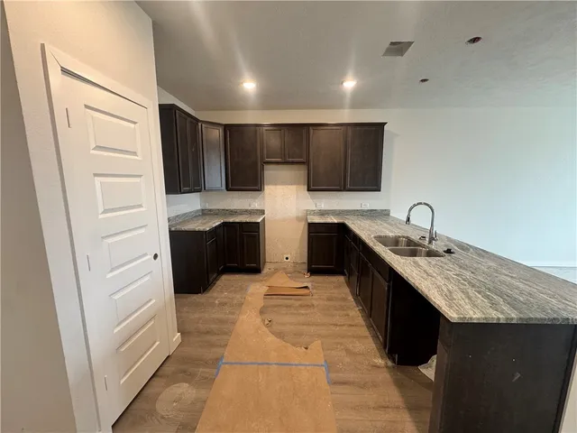 a kitchen with a sink and a refrigerator