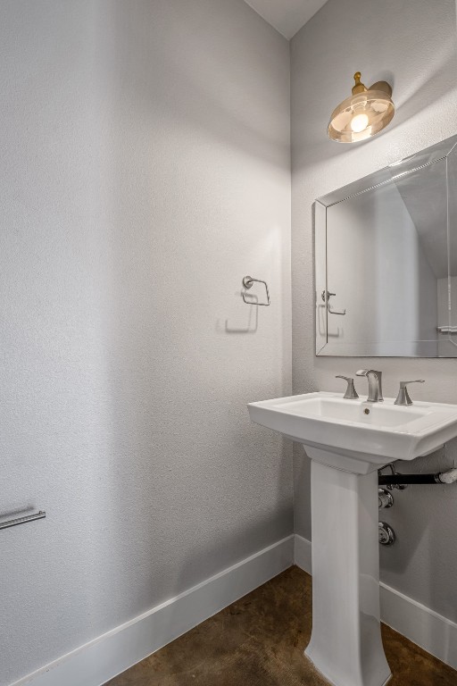 4707 Leslie Avenue, Unit A Austin, TX 78721 - Photo 11 of 24 Bathroom featuring baseboards and concrete flooring