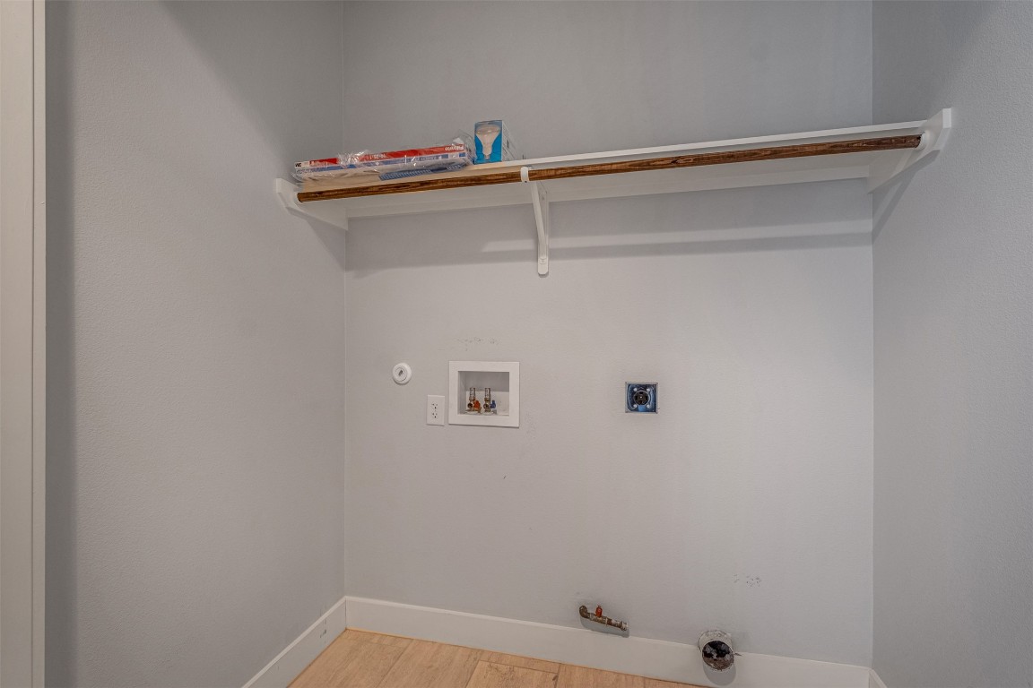 4707 Leslie Avenue, Unit A Austin, TX 78721 - Photo 12 of 24 Laundry room featuring gas dryer hookup, light wood finished floors, and hookup for a washing machine