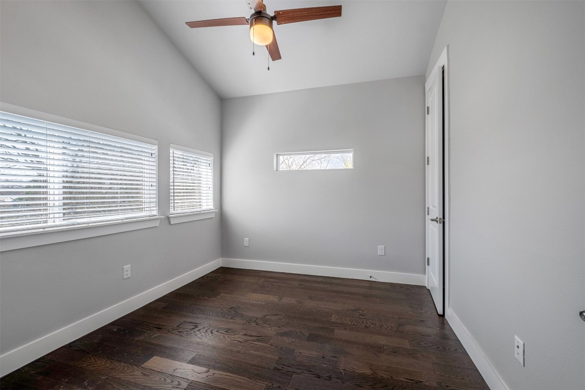 4707 Leslie Avenue, Unit A Austin, TX 78721 - Photo 13 of 24 Spare room with dark wood-style flooring, ceiling fan, and high vaulted ceiling