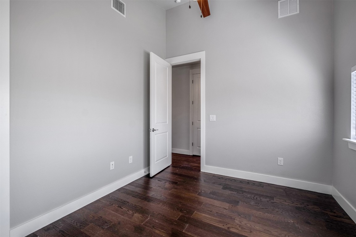 4707 Leslie Avenue, Unit A Austin, TX 78721 - Photo 14 of 24 Spare room with dark wood finished floors and a ceiling fan