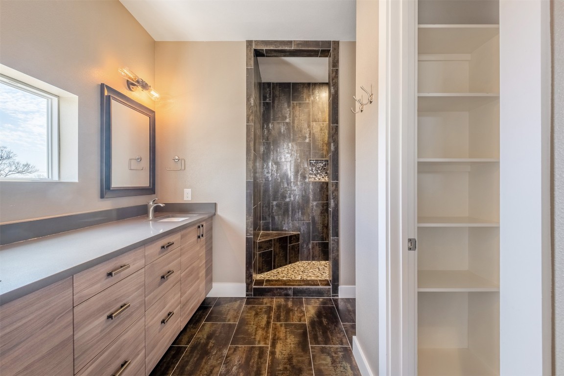 4707 Leslie Avenue, Unit A Austin, TX 78721 - Photo 20 of 24 Full bath with built in shelves, a stall shower, and vanity