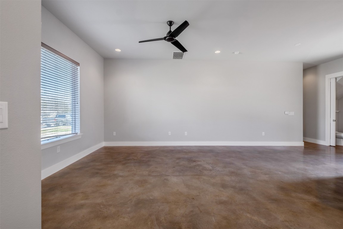 4707 Leslie Avenue, Unit A Austin, TX 78721 - Photo 5 of 24 Unfurnished room featuring finished concrete floors, ceiling fan, and recessed lighting