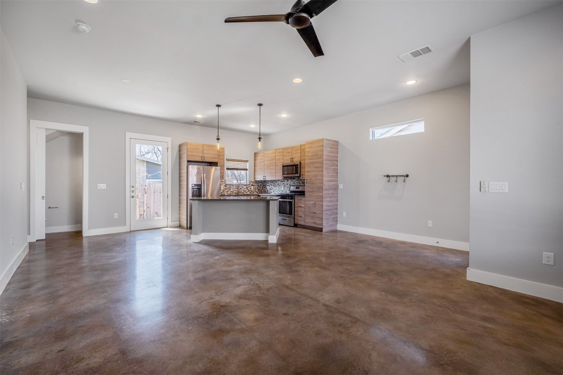 4707 Leslie Avenue, Unit A Austin, TX 78721 - Photo 6 of 24 Unfurnished living room featuring recessed lighting, a ceiling fan, and finished concrete floors