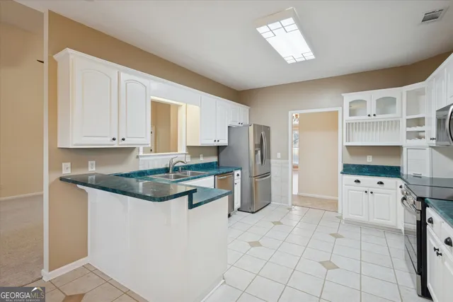 a kitchen with stainless steel appliances granite countertop a refrigerator and a stove