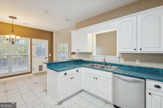 a kitchen with granite countertop white cabinets and white appliances