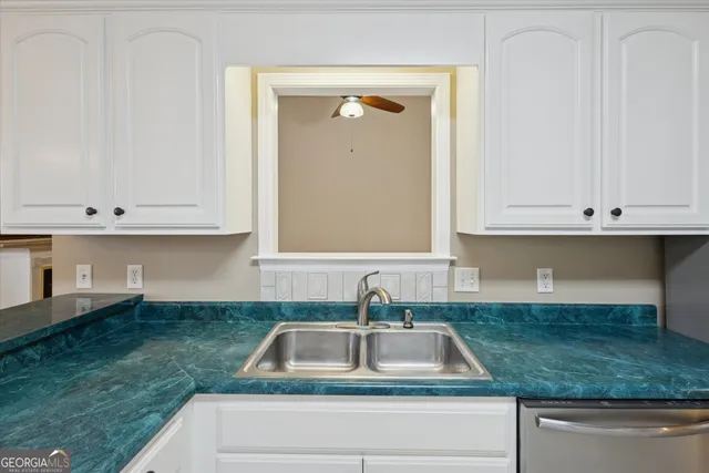 a kitchen that has a sink and a stove