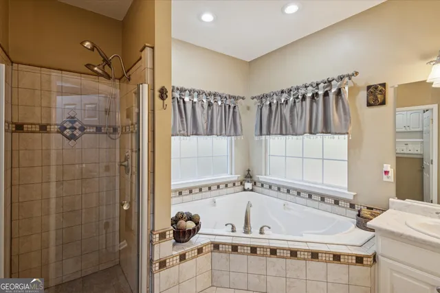 a bathroom with a tub and a shower