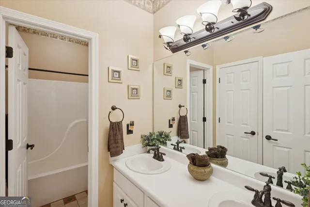 a bathroom with a sink a mirror and a shower