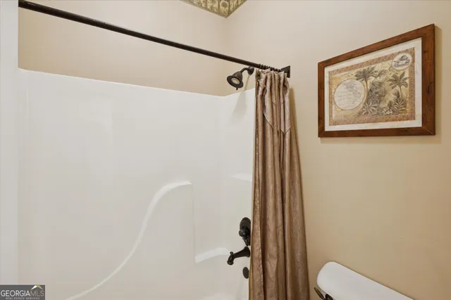 a bathroom with a shower and toilet