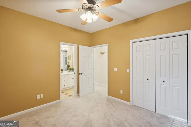 a view of an empty room with closet area