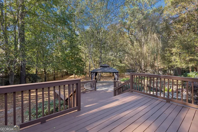 a view of balcony with wooden floor and fence