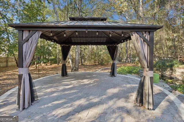 a view of a house with backyard and sitting area