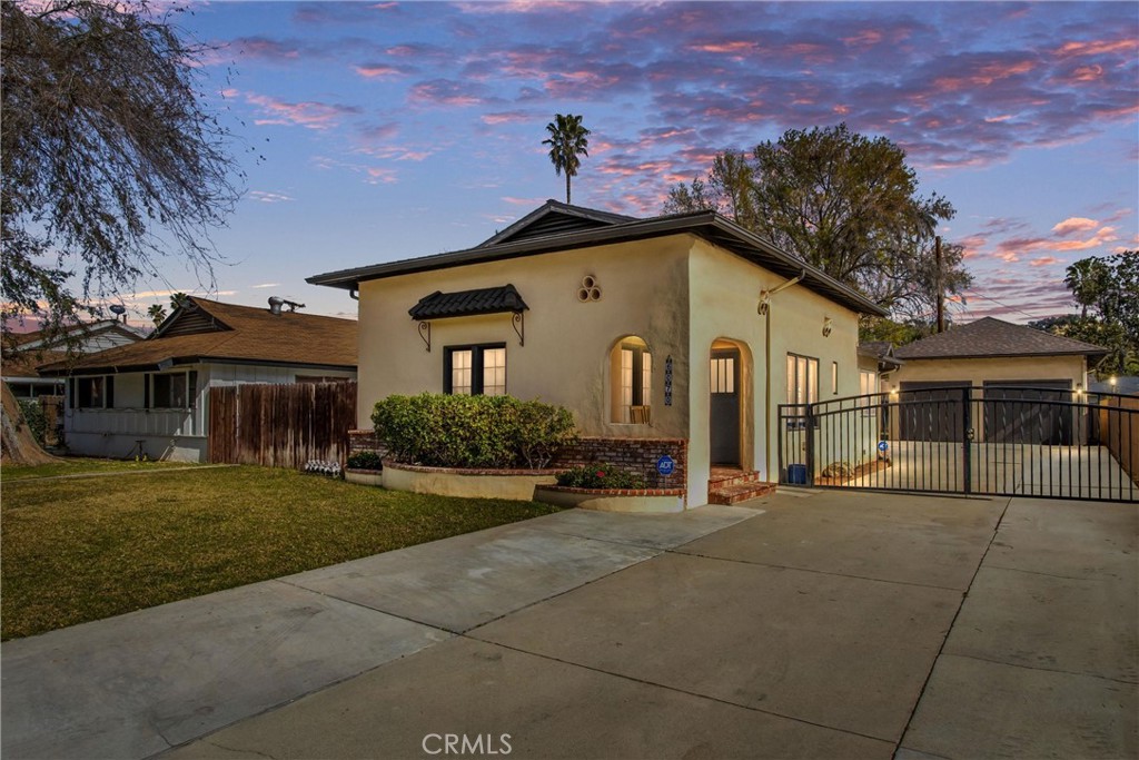 6070 Riverside Avenue Riverside, CA 92506 - Photo 1 of 1 a front view of a house with a garden