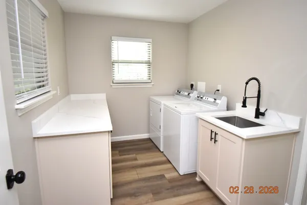a kitchen with a sink a window and cabinets