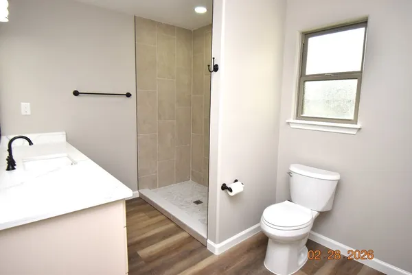 a white toilet sitting next to a bathroom sink