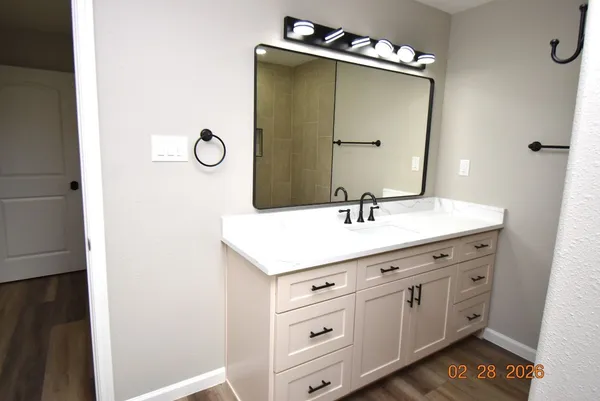 a bathroom with a sink vanity and mirror