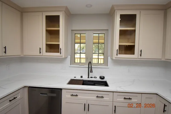 a kitchen with a sink and cabinets