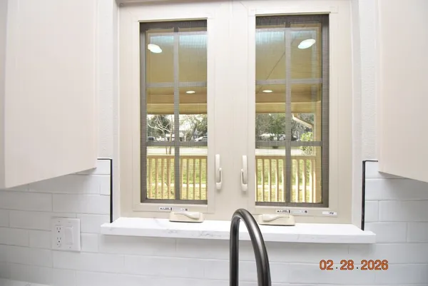 a view of a bathroom with a tub and window