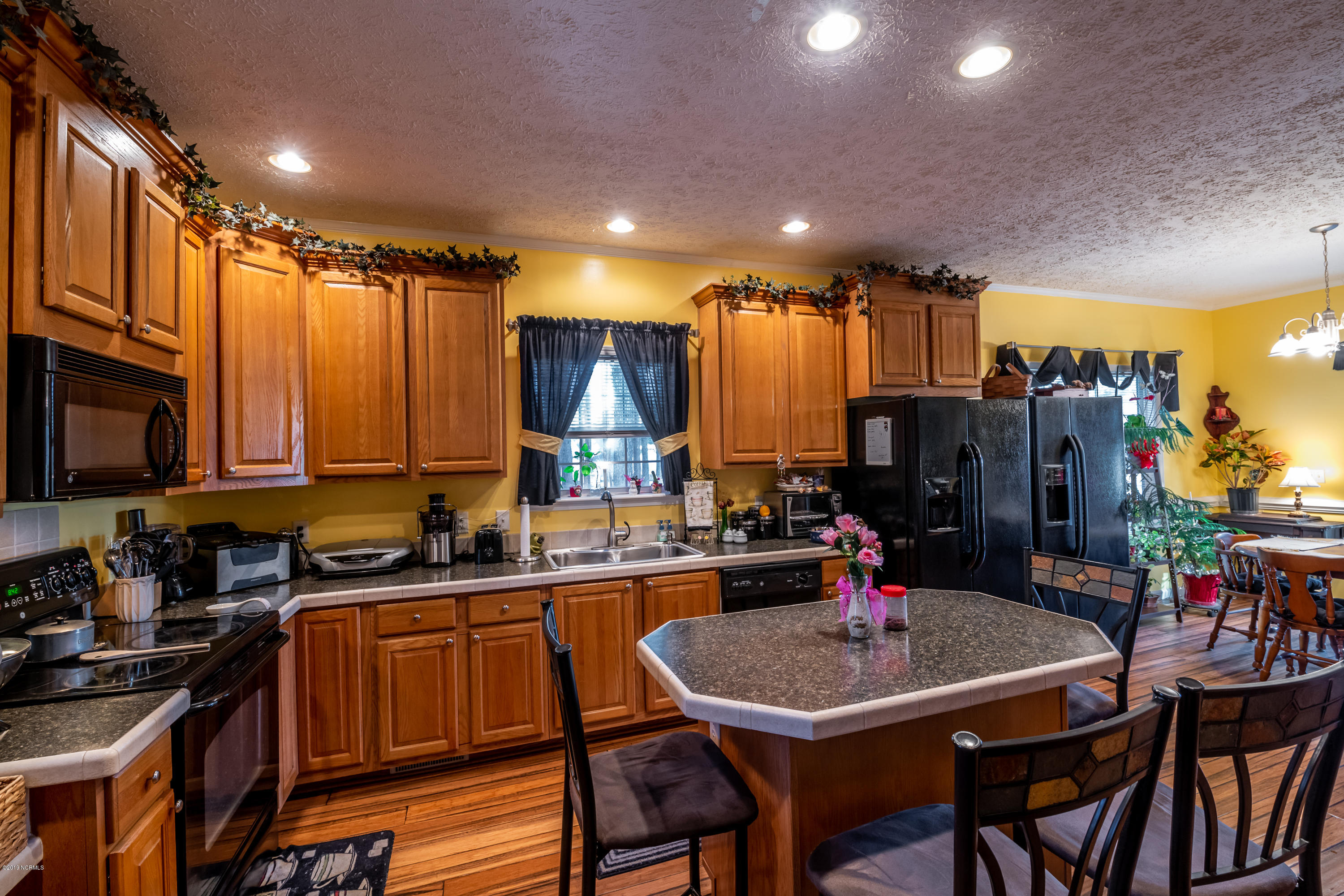 6141 Squirrel Den Road Bailey, NC 27807 - Photo 7 of 29 Kitchen Island providing extra seating & surface working space