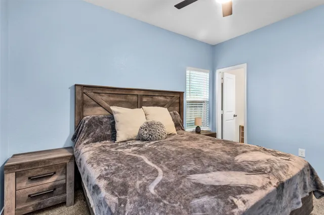 a large bed sitting in a bedroom next to a window