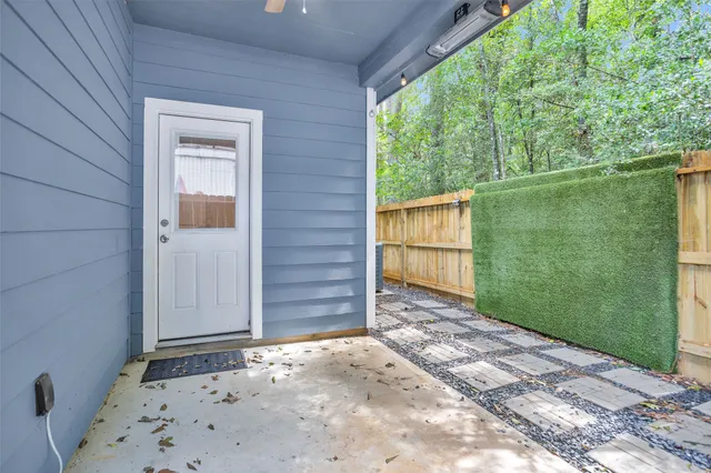 a view of a balcony with wooden floor and fence