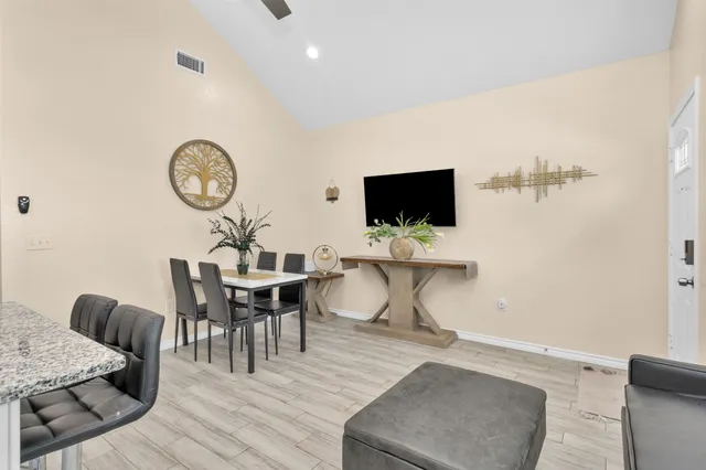 a view of a dining room with furniture and wooden floor