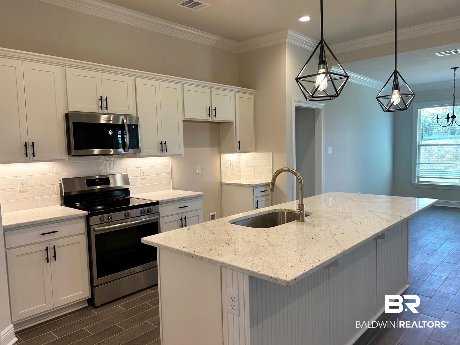 868 Sumter Loop Foley, AL 36535 - Photo 2 of 16 Kitchen featuring a kitchen island with sink, white cabinetry, stainless steel appliances, and light stone countertops