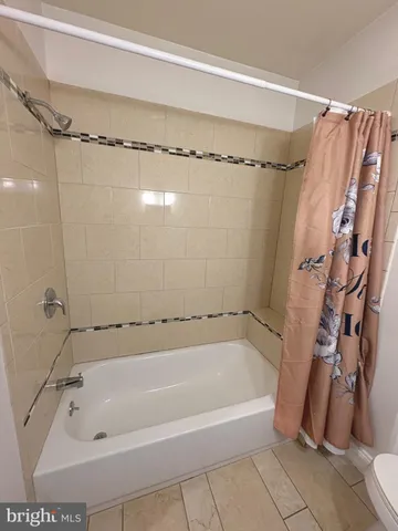 a bathroom with a shower and a tub